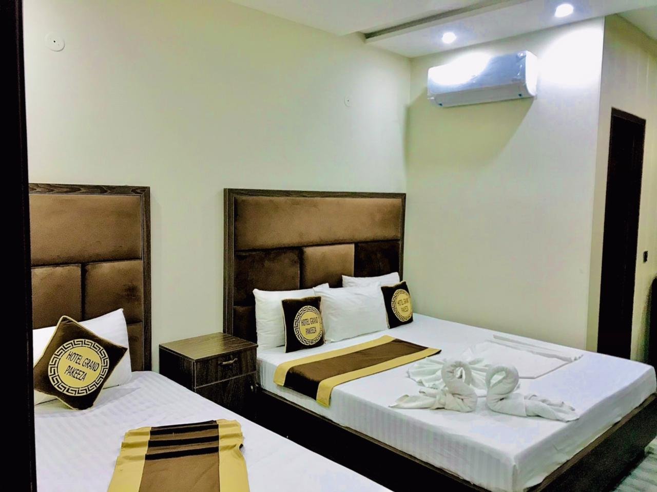 two beds room in hotel grand pakeeza lahore